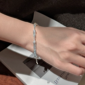 Elegant S925 sterling silver beaded bracelet with light blue gemstones on a white book