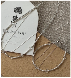 Detailed close-up of double-layer S925 silver beaded bracelet and necklace set with crystals
