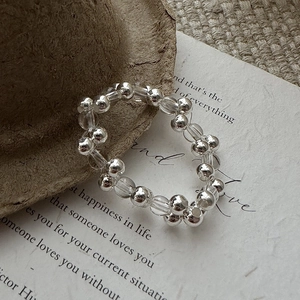 Vintage S925 silver beaded ring featuring clear crystals on literary background paper