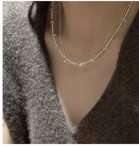 Double-layered S925 sterling silver beaded necklace with clear crystal accents on a model