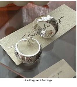 Close-up of S925 sterling silver hoop earrings with irregular crushed ice texture design