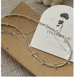 Macro detail of S925 sterling silver beaded necklace with clear crystal beads