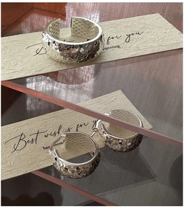 Detail of S925 sterling silver ring and earrings set with hammered texture and mesh lining