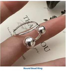 Close-up of a minimalist S925 sterling silver ring with two smooth round beads