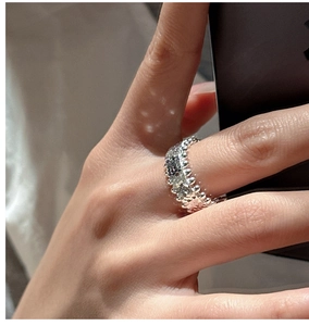 Detailed macro view of silver ring with granular texture and retro beaded edge design