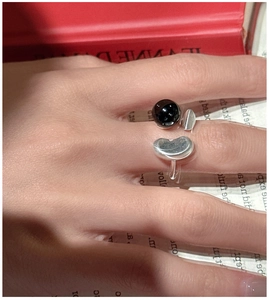 Detail of S925 sterling silver ring set with black onyx bead and iconic bean motif