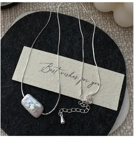 Detail of baroque pearl pendant on S925 silver necklace with adjustable tail chain