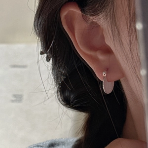Elegant S925 sterling silver pleated fan stud earrings worn by a model in a close-up view