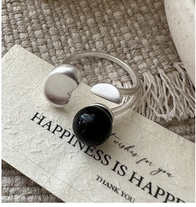 Close-up of S925 sterling silver ring with black onyx bead and matte silver bean detail