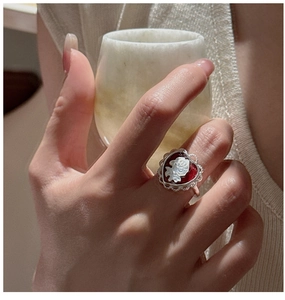 Detailed view of an S925 silver vintage red cameo heart ring with floral relief