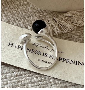 Close-up of vintage S925 sterling silver open ring with matte finish and black agate stone