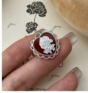 Detailed close-up of a vintage S925 silver ring featuring a red heart rose cameo