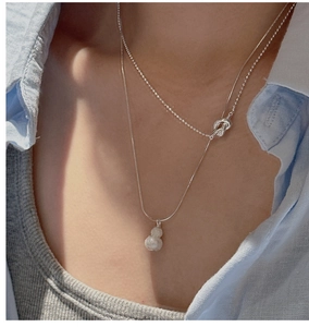 Detail of S925 silver double-layered necklace featuring a matte gourd pendant and knot link