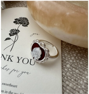 Macro detail of S925 silver ring featuring a red heart cameo rose and adjustable band
