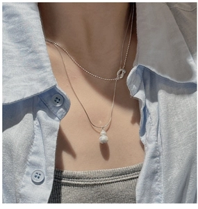 Detail of S925 sterling silver double-layer necklace with a matte finish gourd pendant