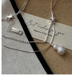 Macro shot of S925 sterling silver double-layer necklace with frosted gourd pendant