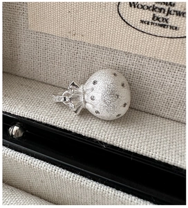 Macro view of S925 sterling silver lucky bag pendant with matte finish and cubic zirconia