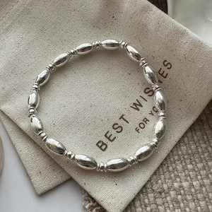 Minimalist S925 sterling silver beaded bracelet with polished oval beads and textured spacers
