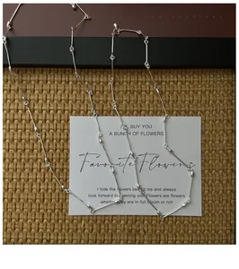 Artistic layout of S925 sterling silver bamboo joint necklace on aesthetic cards