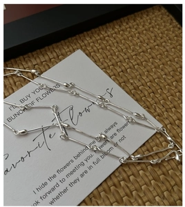 Detailed close-up of S925 sterling silver bamboo joint chain necklace on a card