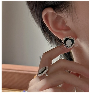 Detail of vintage cameo jewelry set with silver hollow frames on model wearing
