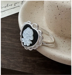 Detailed macro view of vintage S925 silver ring featuring heart-shaped rose cameo design