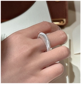 Detailansicht eines S925 Silberrings mit gebürsteter Metallstruktur am Finger getragen