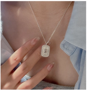 Macro detail of vintage square zircon pendant on S925 sterling silver chain necklace