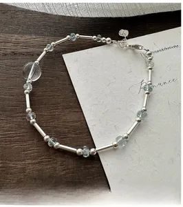 Macro shot of S925 sterling silver beaded bracelet with aquamarine stones and S925 tag