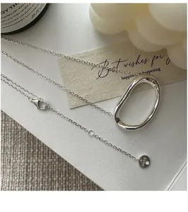 Detail of S925 sterling silver chain featuring an AG925 hallmark tag on an oval necklace