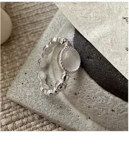 Detailed view of S925 sterling silver ring with textured band and white jadeite gem