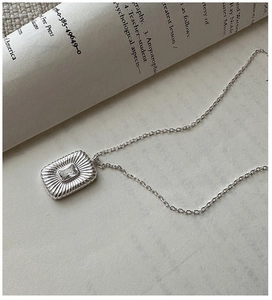 Macro detail of S925 silver necklace featuring a rectangular radiant zircon pendant