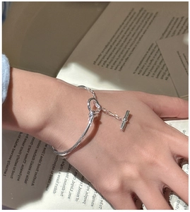 Detail of S925 silver OT buckle bracelet with chain design on a vintage book
