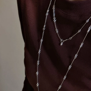 Elegant S925 sterling silver bamboo joint layered necklace on a dark knit sweater