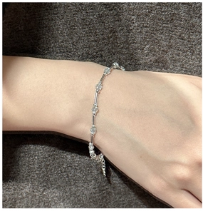 Close-up of S925 sterling silver bracelet with aquamarine crystals on a knit fabric