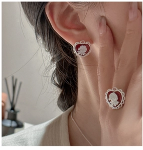 Close-up of S925 silver heart earring and ring with red rose cameo relief detail