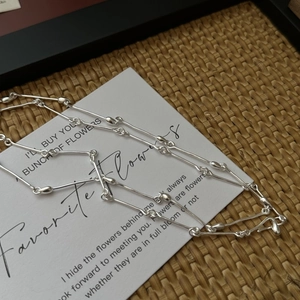Minimalist S925 sterling silver bamboo joint chain necklace on artistic white card background