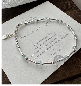 Macro shot of S925 sterling silver bracelet with blue crystal beads and heart tag