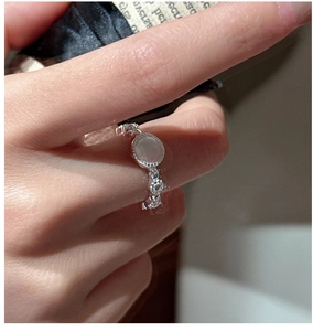 Close-up of S925 sterling silver ring with white moonstone and vintage twisted band detail