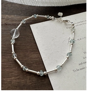 Detailed macro view of S925 sterling silver beaded bracelet with blue aquamarine crystal