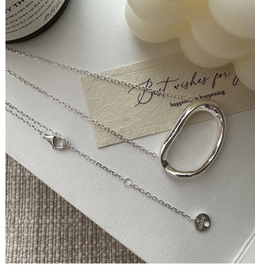 Detailed shot of S925 silver minimalist necklace with oval pendant and lobster clasp