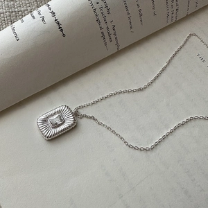 Retro S925 sterling silver necklace with square zircon pendant on vintage book pages