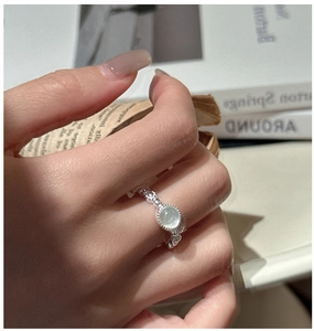 Detailed view of an S925 silver ring featuring a round jade gemstone on a beaded band