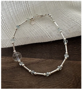 Detail of S925 silver beaded bracelet featuring blue aquamarine and crystal charms