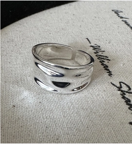 Close-up of irregular liquid texture on adjustable S925 sterling silver ring band