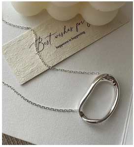Detailed close-up of S925 sterling silver oval pendant necklace with a liquid mirror finish