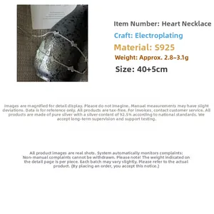 Close-up of S925 sterling silver heart necklace draped on a textured black vase