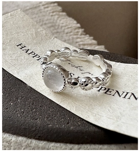 Macro shot of S925 sterling silver ring with water jade gemstone and beaded texture