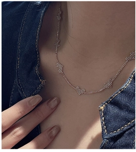 Macro shot of rose gold S925 sterling silver heart charms on a delicate clavicle chain