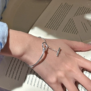 Elegant S925 sterling silver bangle featuring a retro toggle clasp on a book background